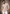 A man wearing a beige long-sleeve kurta with a multicolor geometric pattern,