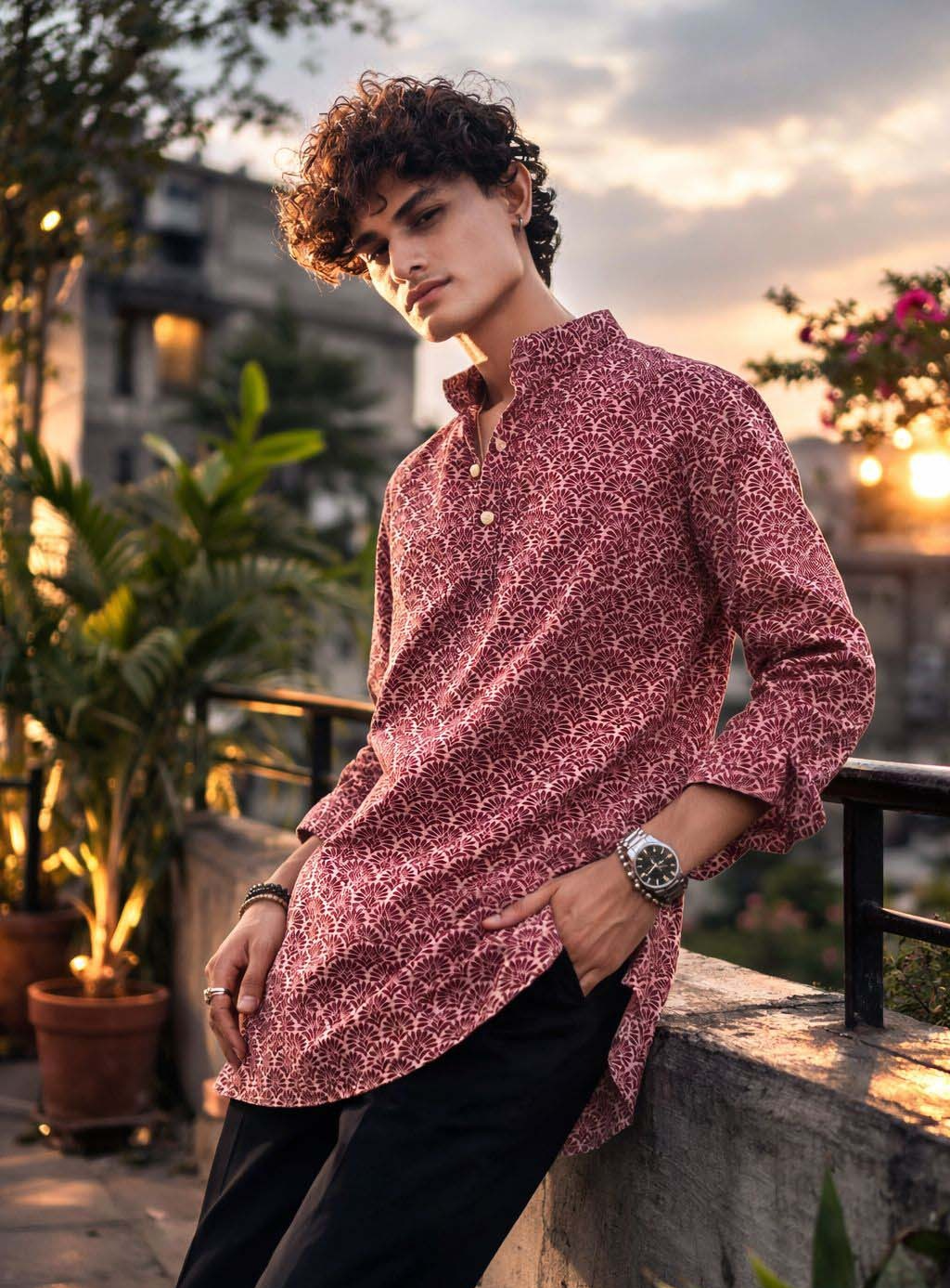 A man wearing a long-sleeve, high-collar kurta with a red and white geometric pattern.