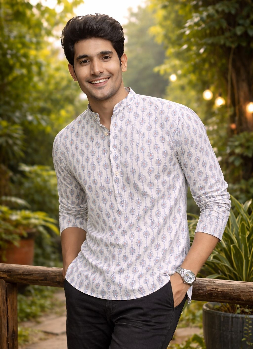 A man wearing a white long-sleeve kurta with a blue geometric pattern, .