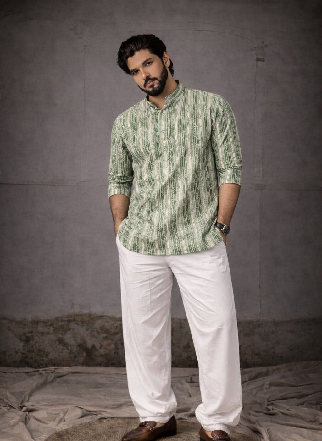 A man wearing a green and white kurta